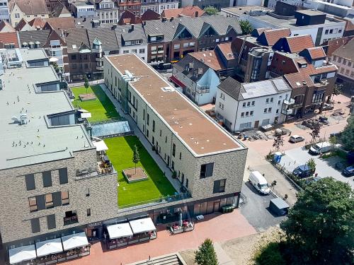 Bird's eye view onto a green roof with lawn in the city